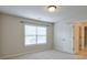 Bedroom featuring neutral walls and carpet, a window, and a view to the hallway at 1211 Fawndale Nw Dr, Kennesaw, GA 30152