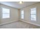Bedroom with three windows and carpeted floors. Great natural light! at 1211 Fawndale Nw Dr, Kennesaw, GA 30152