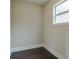 Empty walk-in closet featuring dark hardwood floors, white trim, and one window at 1211 Fawndale Nw Dr, Kennesaw, GA 30152