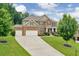 Charming brick two-story home featuring a manicured front lawn and a three-car garage at 1211 Fawndale Nw Dr, Kennesaw, GA 30152
