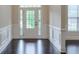 Bright foyer featuring hardwood floors, elegant wainscoting, and a glass-paneled front door at 1211 Fawndale Nw Dr, Kennesaw, GA 30152