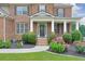 Charming home entrance with brick accents, beautiful landscaping, and a welcoming front porch at 1211 Fawndale Nw Dr, Kennesaw, GA 30152