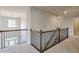 Hallway showcasing railing with dark wood and black spindles and neutral carpet at 1211 Fawndale Nw Dr, Kennesaw, GA 30152