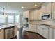 Bright kitchen features stainless steel appliances, granite counters, white cabinets, and dark hardwood floors at 1211 Fawndale Nw Dr, Kennesaw, GA 30152