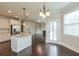 Open-concept kitchen and living area with stainless steel appliances, granite countertops, and hardwood floors at 1211 Fawndale Nw Dr, Kennesaw, GA 30152