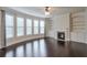 Cozy living room featuring a fireplace, built-in shelving, and large windows for ample natural light at 1211 Fawndale Nw Dr, Kennesaw, GA 30152