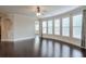Open living room with hardwood floors, large windows, and decorative alcove leading to other areas at 1211 Fawndale Nw Dr, Kennesaw, GA 30152