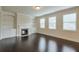 Bright living room boasts dark hardwood floors, built-in bookshelves and fireplace, and large windows at 1211 Fawndale Nw Dr, Kennesaw, GA 30152