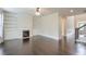 Bright living room with fireplace, built-in bookcases, hardwood floors, and staircase access at 1211 Fawndale Nw Dr, Kennesaw, GA 30152