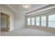 Spacious main bedroom with high ceilings, carpet, and large windows with natural light at 1211 Fawndale Nw Dr, Kennesaw, GA 30152