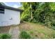 View of the home's backyard featuring a wooded area with a path leading through the trees at 1261 Calhoun Sw Ter, Atlanta, GA 30314