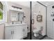 Bathroom features modern fixtures, double sinks, glass shower with black accents, and tiled walls at 1261 Calhoun Sw Ter, Atlanta, GA 30314