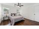 Bedroom with decorative trim, dark hardwood floors, with a plush queen bed at 1261 Calhoun Sw Ter, Atlanta, GA 30314