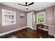 Bedroom featuring a ceiling fan and desk area with natural light, complemented by wood floors at 1261 Calhoun Sw Ter, Atlanta, GA 30314