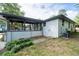 A backyard view of the home featuring a covered deck with metal railings and white painted brick at 1261 Calhoun Sw Ter, Atlanta, GA 30314