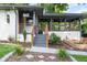 Welcoming front entry featuring modern railings, stone steps, and a stylish covered porch at 1261 Calhoun Sw Ter, Atlanta, GA 30314