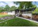 Inviting front yard with lush lawn and modern walkway leading to covered porch and front entrance at 1261 Calhoun Sw Ter, Atlanta, GA 30314