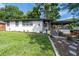 Charming home featuring a well-manicured front yard and stylish walkway to the front porch at 1261 Calhoun Sw Ter, Atlanta, GA 30314