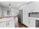 Bright kitchen with white cabinets and stainless steel appliances; open concept design at 1261 Calhoun Sw Ter, Atlanta, GA 30314