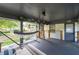 Cozy covered porch with a hammock, outdoor seating, and views of a lush backyard at 1261 Calhoun Sw Ter, Atlanta, GA 30314