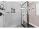 A modern shower features black hardware and white subway tile at 1261 Calhoun Sw Ter, Atlanta, GA 30314