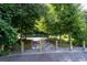 A view of the walking path entrance surrounded by mature trees at 1261 Calhoun Sw Ter, Atlanta, GA 30314