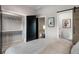 Bedroom with a modern closet with hanging rods, and adjacent full bathroom with a floating vanity at 2328 Mason Drive Dr, Atlanta, GA 30316