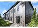 Modern townhome exterior with a gray siding, windows, and a well manicured lawn at 2328 Mason Drive Dr, Atlanta, GA 30316