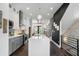 Open-concept kitchen with a large island, stainless steel appliances, and stylish modern lighting at 2328 Mason Drive Dr, Atlanta, GA 30316