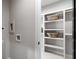 Bright laundry room with open shelving offering plenty of storage space for supplies at 2328 Mason Drive Dr, Atlanta, GA 30316