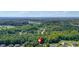 An aerial view of the property with expansive green spaces and a tree-lined horizon at 127 Muirwood Dr, Temple, GA 30179