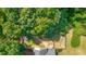 Aerial view showcasing a home's backyard bordered with thick green trees offering privacy at 127 Muirwood Dr, Temple, GA 30179