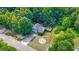 Aerial view showing a charming home with a spacious front yard and extended driveway at 127 Muirwood Dr, Temple, GA 30179