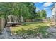 A spacious grassy backyard that is fully fenced, and features a trampoline and play set at 127 Muirwood Dr, Temple, GA 30179