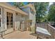 View of home's rear exterior with a door that leads to a wooden back deck with access to the backyard at 127 Muirwood Dr, Temple, GA 30179