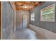 Unfinished basement room featuring exposed ceiling and wood laminate walls and floors at 127 Muirwood Dr, Temple, GA 30179