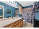 Bright bathroom features a single sink vanity and shower with rustic wooden-look curtain at 127 Muirwood Dr, Temple, GA 30179