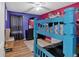 Bedroom featuring a bunk bed and pink and purple walls and wood floors at 127 Muirwood Dr, Temple, GA 30179