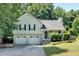 Charming two-story home with a well-maintained lawn, two-car garage, and traditional architectural details at 127 Muirwood Dr, Temple, GA 30179