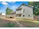 Rear exterior view of a two-story home with a backyard and a wooden deck with access stairs at 127 Muirwood Dr, Temple, GA 30179