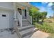 Welcoming front entrance with a charming porch, wooden steps, and well-kept landscaping enhancing curb appeal at 127 Muirwood Dr, Temple, GA 30179
