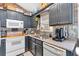 Kitchen featuring painted cabinets, stainless steel sink, and modern appliances at 127 Muirwood Dr, Temple, GA 30179