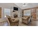 Cozy living room featuring a fireplace and comfortable seating; wood-look floors and vaulted ceiling at 127 Muirwood Dr, Temple, GA 30179
