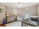Bedroom featuring modern gray furniture, natural light, and tree patterned curtains at 177 Coopers Pond Dr, Lawrenceville, GA 30044