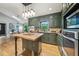 Modern kitchen with stainless steel appliances, island, and custom cabinets, and skylight at 177 Coopers Pond Dr, Lawrenceville, GA 30044
