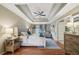 Spacious main bedroom with tray ceiling, hardwood floors, and a cozy seating area at 177 Coopers Pond Dr, Lawrenceville, GA 30044