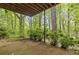 Patio view surrounded by lush greenery and mature trees, creating a private outdoor space at 1832 Tree Top Ct, Marietta, GA 30062