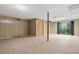 View of the open basement area with paneled walls, a door, and sliding glass doors at 1832 Tree Top Ct, Marietta, GA 30062