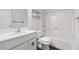 Bathroom with white fixtures, including a vanity, toilet, and shower-tub combination at 1832 Tree Top Ct, Marietta, GA 30062