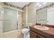 Vintage-style bathroom with a sink, toilet, and shower featuring floral wallpaper and trim at 1832 Tree Top Ct, Marietta, GA 30062